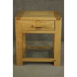 A contemporary oak bedside table, with a single drawer, on rectilinear legs joned by stretchers. H.