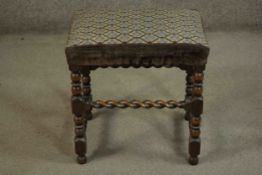 A country antique style oak stool with stuffover tapestry seat on stretchered barleytwist supports