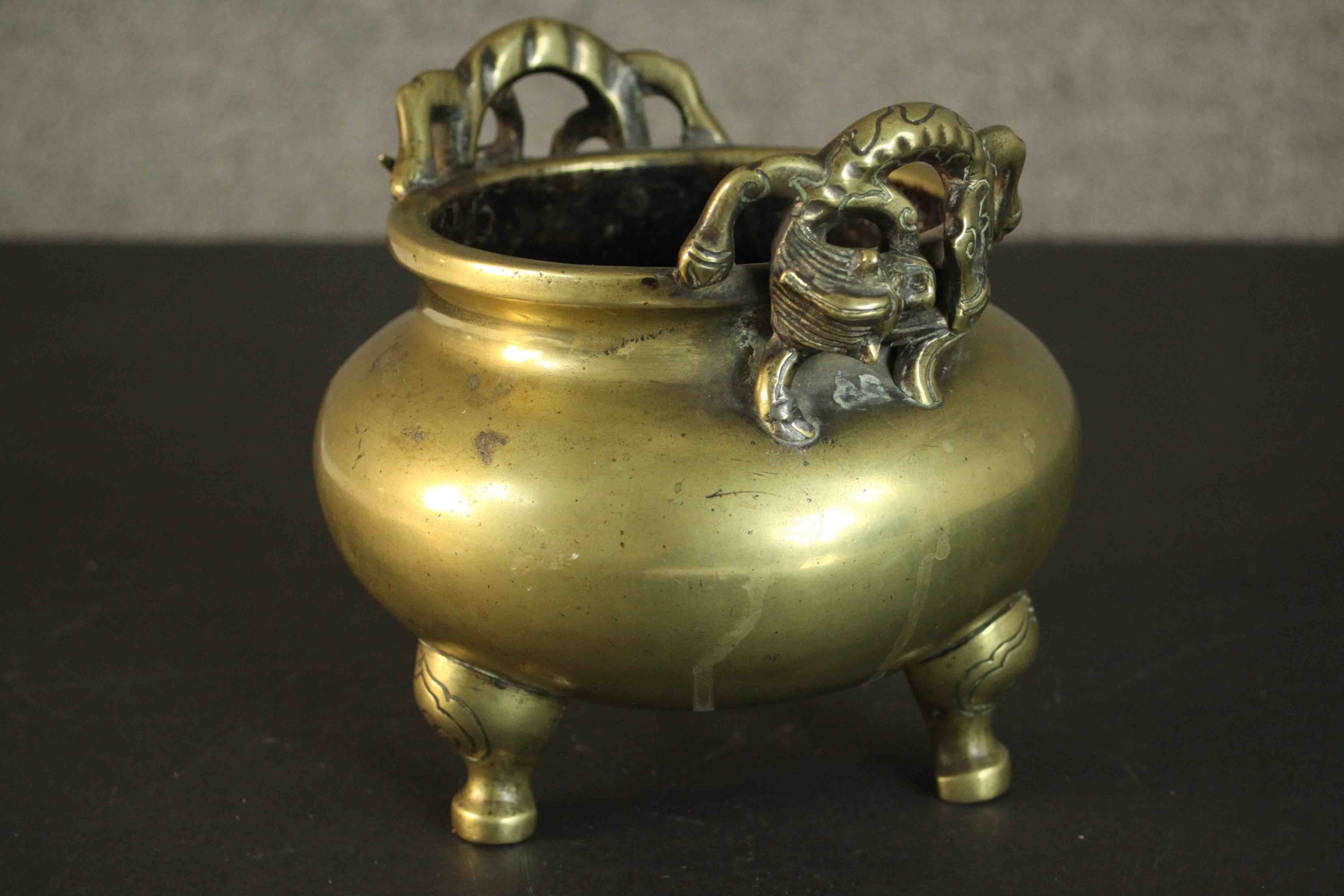 A three footed Chinese brass censer with dragon form handles. Apocryphal Ming Chenghua mark to base. - Image 3 of 6