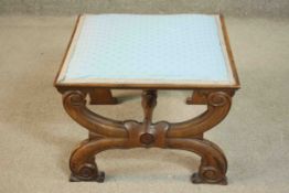 A late 19th century French walnut footstool, of square form upholstered in light blue fabric, on