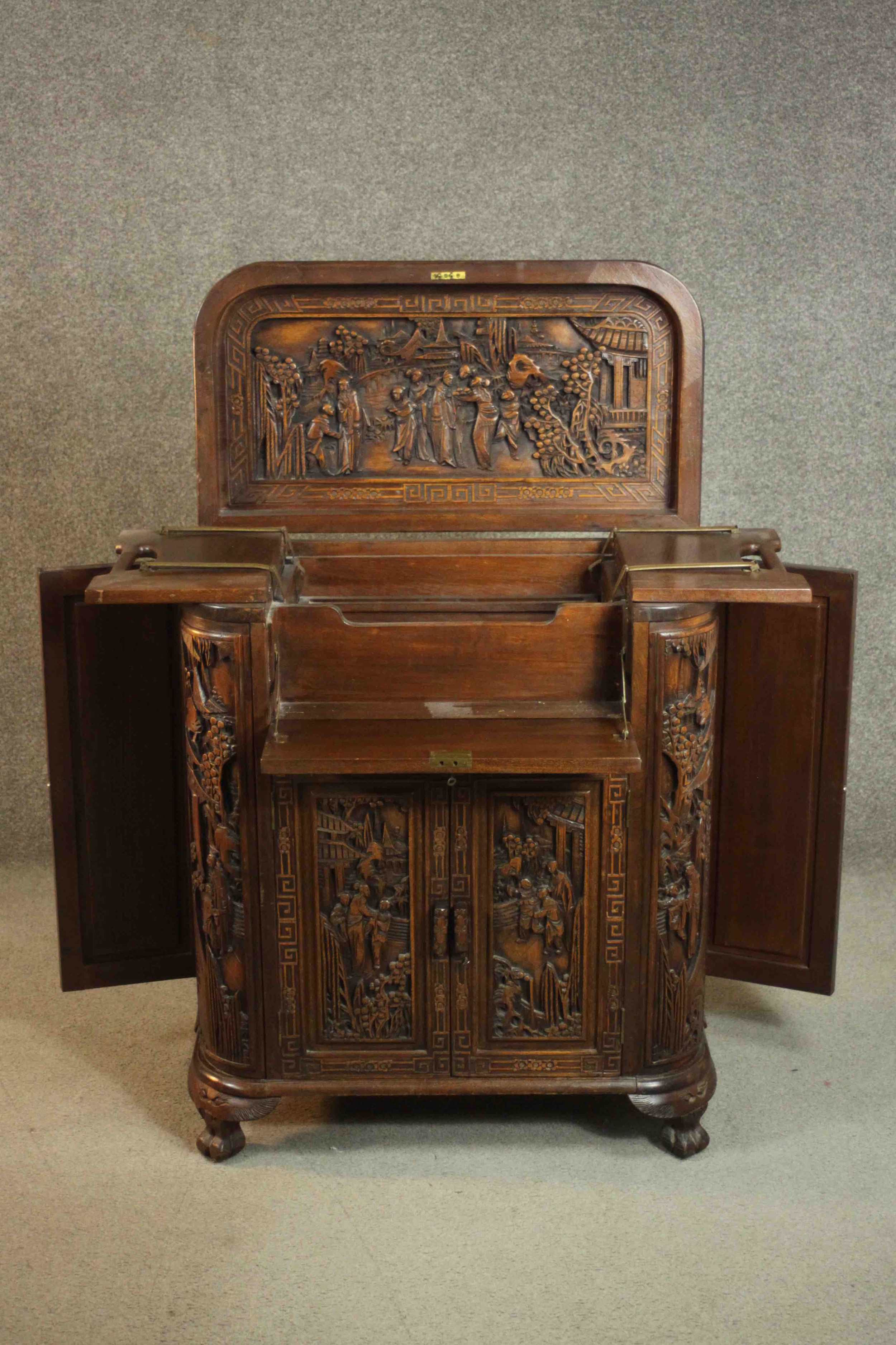 An early 20th century Chinese carved hardwood cabinet with central fitted drinks section. H.87 W. - Image 6 of 14