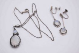 An early 20th century white metal (tests as silver) and moonstone necklace and earrings. The pierced