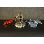A collection of hand painted porcelain, including a red glaze bull and a pair of dolphins among