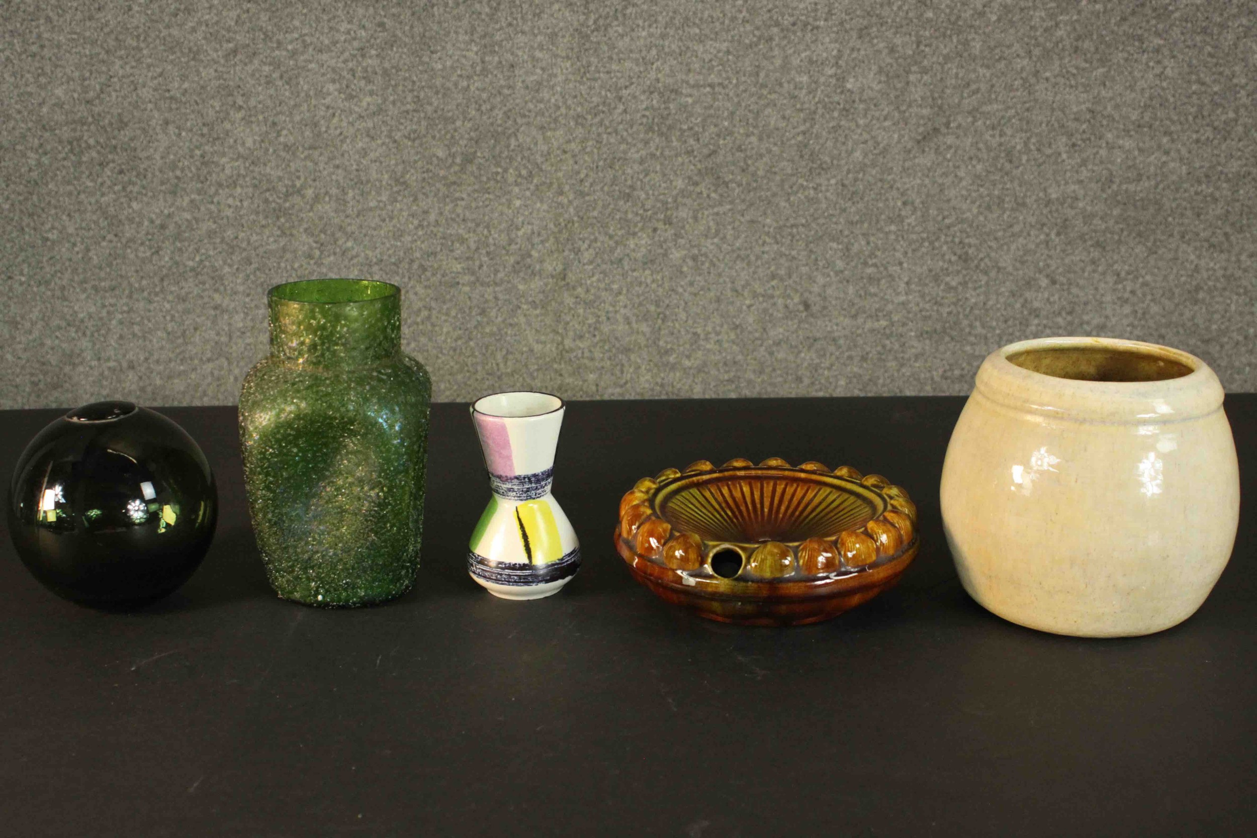 A collection of ceramics and glass, including a green glass fishing float and green lustre