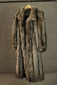 A vintage silk lined Racoon fur long length coat. L.127cm.