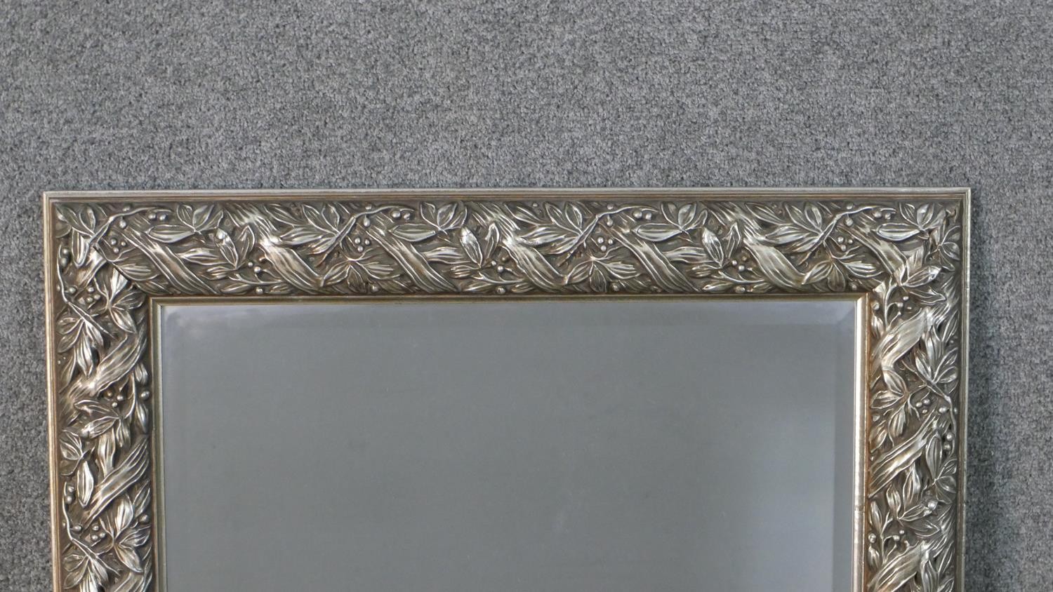 A silver painted moulded foliate and ribbon design wall mirror. H.107 W.78cm - Image 3 of 4