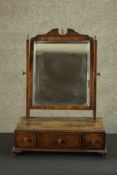A 19th century mahogany dressing table mirror with bevelled swing plate above base fitted with
