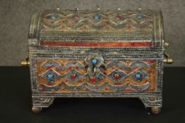 A Middle Eastern or North African dome topped trunk, with red and blue cabochons and worked white