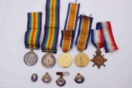 A collection of five WW1 medals along with four military badges. Three medals for 14761 PTE E.