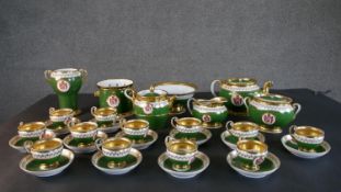 A Paris porcelain (Feuillet) twelve person tea set c.1840, finely painted with armorial crest on