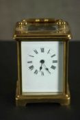 A 19th century gilt brass and plate carriage clock with white enamel dial and black Roman