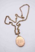 A 9ct rose gold oval engraved locket on a 9ct rolo link chain with push barrel clasp. Two hand