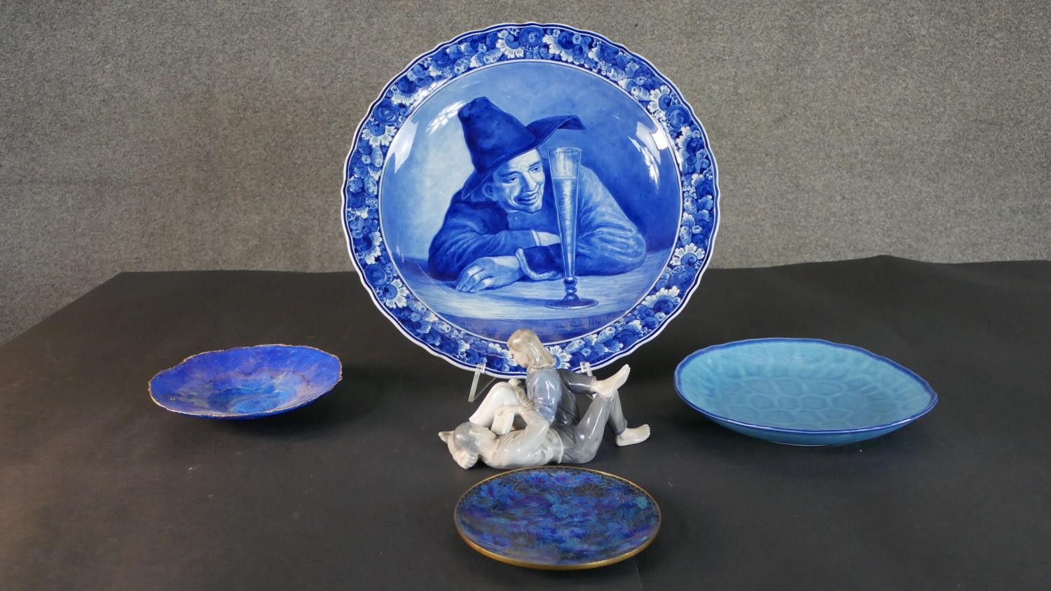 A collection of plates and a ceramic figure, including a Royal Copenhagen hand painted porcelain