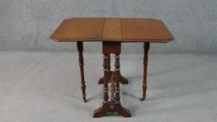 A 19th century mahogany drop flap Sutherland table on turned tapering supports. H.52 W.71 D.51cm (