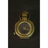 A cased WWI military brass bodied pocket compass, the base with broad arrow, dated and numbered to
