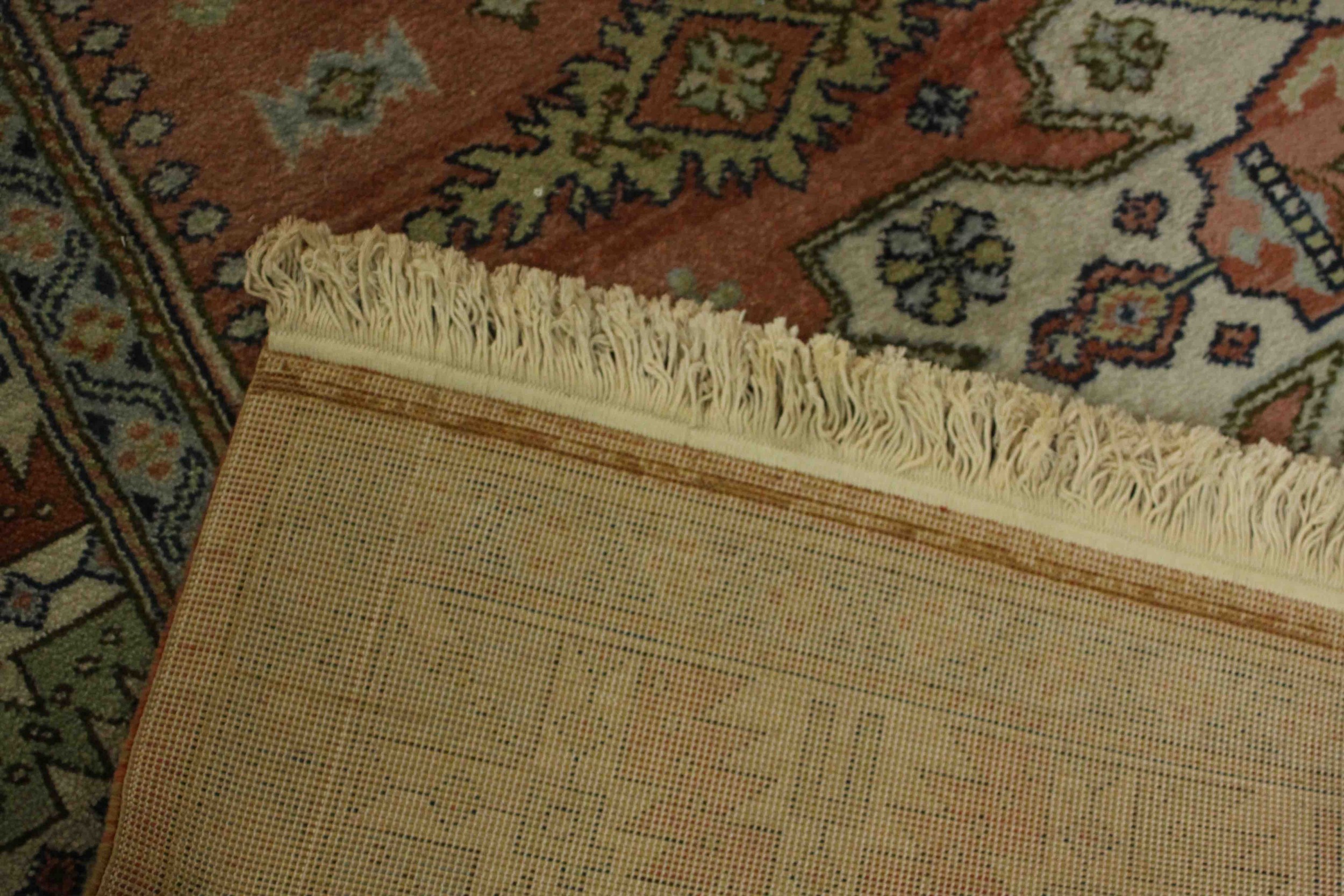 A Caucasian motif carpet with repeating stylised motifs on a terracotta field within geometric - Image 6 of 6