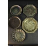A collection of five 19th century Indian engraved brass plates, each with a different design. One