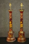 A pair of reproduction toleware table lamps, of cylindrical columnar form with gilt Oriental designs