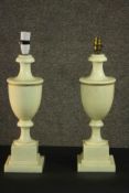 A pair of 20th century classical style white marble urn form lamps, on a square section socle