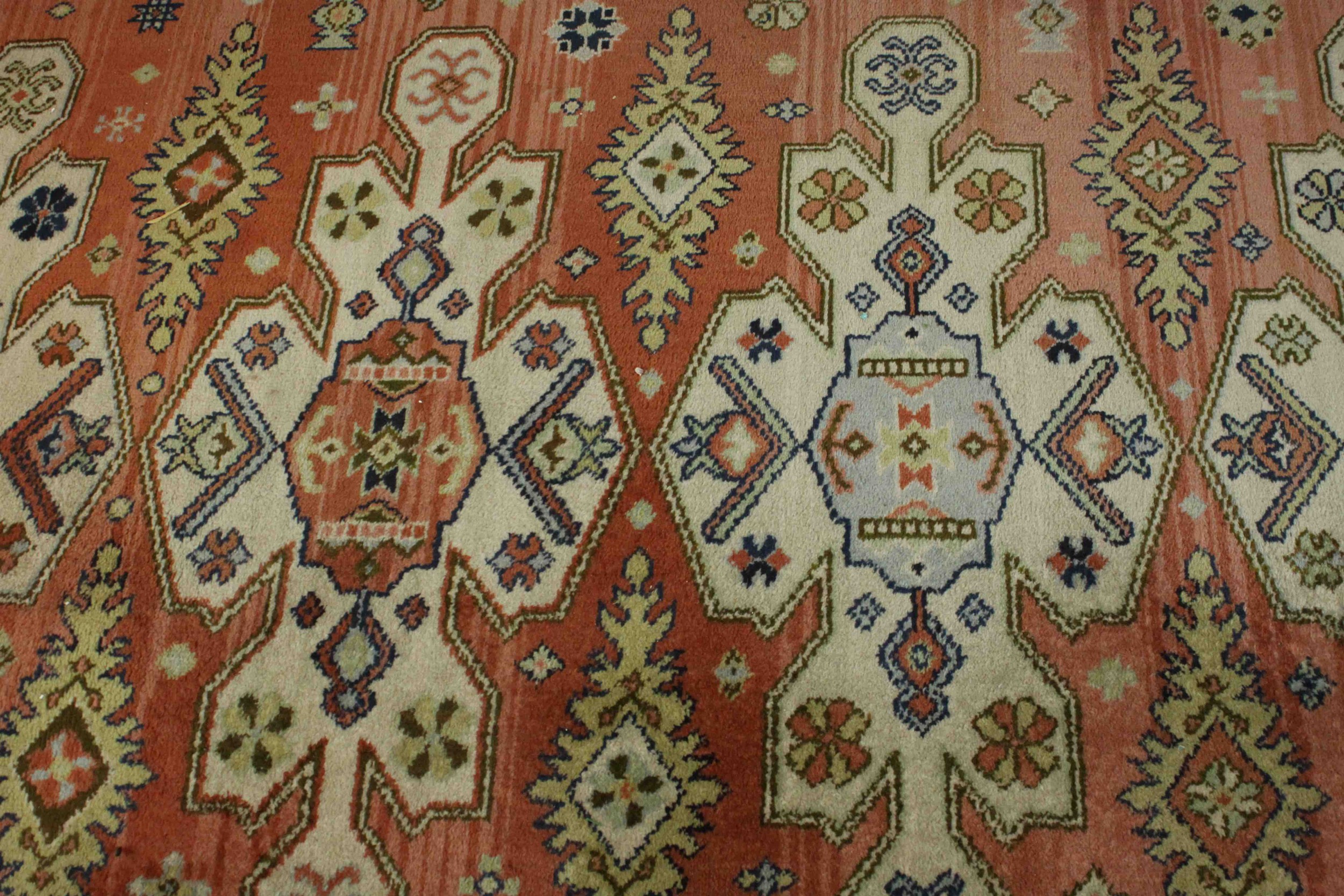 A Caucasian motif carpet with repeating stylised motifs on a terracotta field within geometric - Image 4 of 6