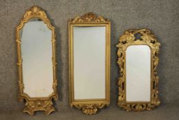 An 18th century carved giltwood framed mirror of small proportions, carved with scrolling vines,