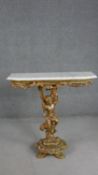 A 19th century console table with canted marble top above carved giltwood figural support on