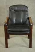 A circa 1970s Dyrlund Danish hardwood open armchair, the back and seat upholstered in black leather,