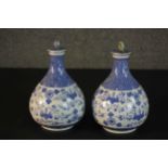 A pair of early 20th century Chinese blue and white hand painted porcelain lidded bottle vases