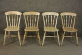 A set of four late 20th century oak kitchen chairs, with a bar back over turned spindles above a