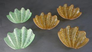Five Art Deco moulded frosted glass clamshell lamp shades, three amber and two pale green. W.25cm
