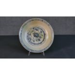A 19th century Chinese porcelain hand painted celadon glaze bowl. Decorated with a stylised floral