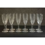 A set of twelve hand cut Baccarat crystal petal faceted champagne flutes, etched maker's stamp to