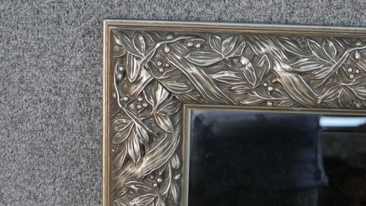 A silver painted moulded foliate and ribbon design wall mirror. H.107 W.78cm - Image 4 of 4