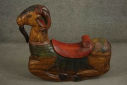 A child's Indonesian carved and painted rocking ram or goat, with curved horns, a beard, and a