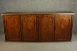 A 19th century satinwood sideboard, with a later rectangular top on four arched panelled doors