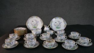 A twelve person hand painted Minton Emperor's Garden pattern part tea set. Makers mark to the