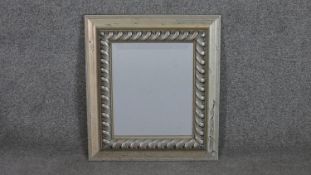 A contemporary bevelled plate mirror in silvered frame. H.45.5 W.40.5cm