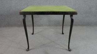 An ebonised folding bridge table, the square green baize top on cabriole legs. H.64 W.76 D.76cm