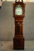 A George III Sheraton style flame mahogany and satinwood inalaid longcase clock, the hood with a