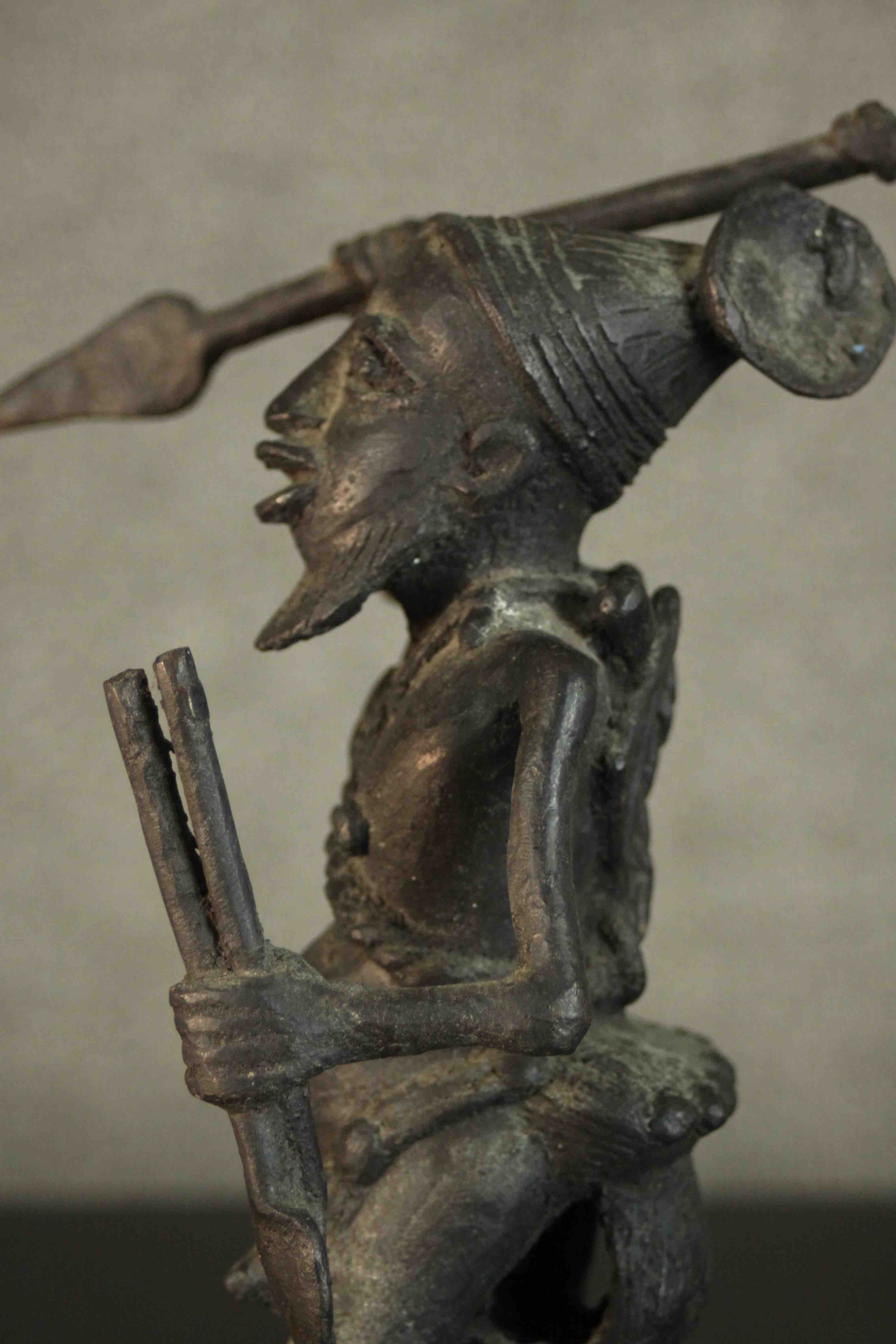 An African tribal bronze figure of a warrior throwing a spear. H.31 W.12cm - Image 5 of 7