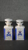 A pair of 19th century hand painted and gilded French porcelain perfume bottles with stoppers.