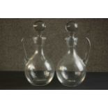 A pair of hand blown Baccarat crystal handled decanters with stoppers, etched maker's stamp to base.