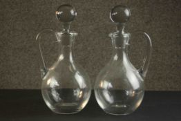 A pair of hand blown Baccarat crystal handled decanters with stoppers, etched maker's stamp to base.