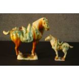 Two Tang dynasty style ceramic horses with applied green and ochre glazes. H.40 W.43 D.18cm. (