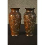 A pair of Meji period Japanese relief bronze and mixed metal vases. Each one decorated with storks