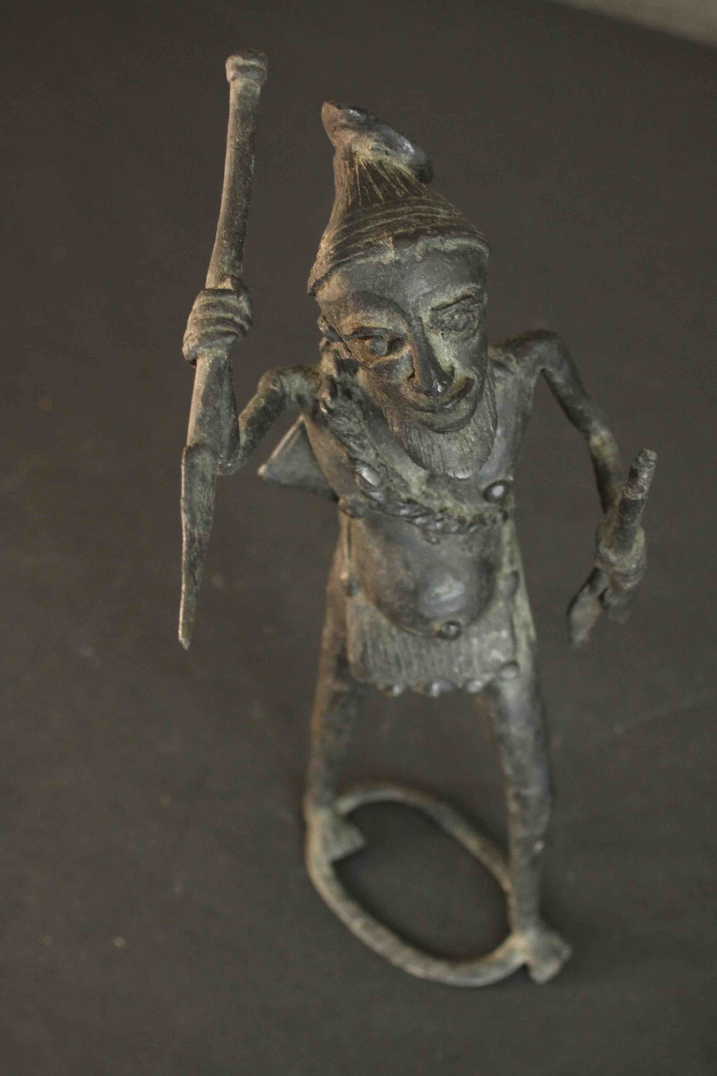 An African tribal bronze figure of a warrior throwing a spear. H.31 W.12cm - Image 7 of 7