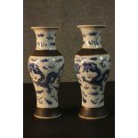 A pair of Chinese early 20th century crackle glaze blue and white dragon design vases. Character