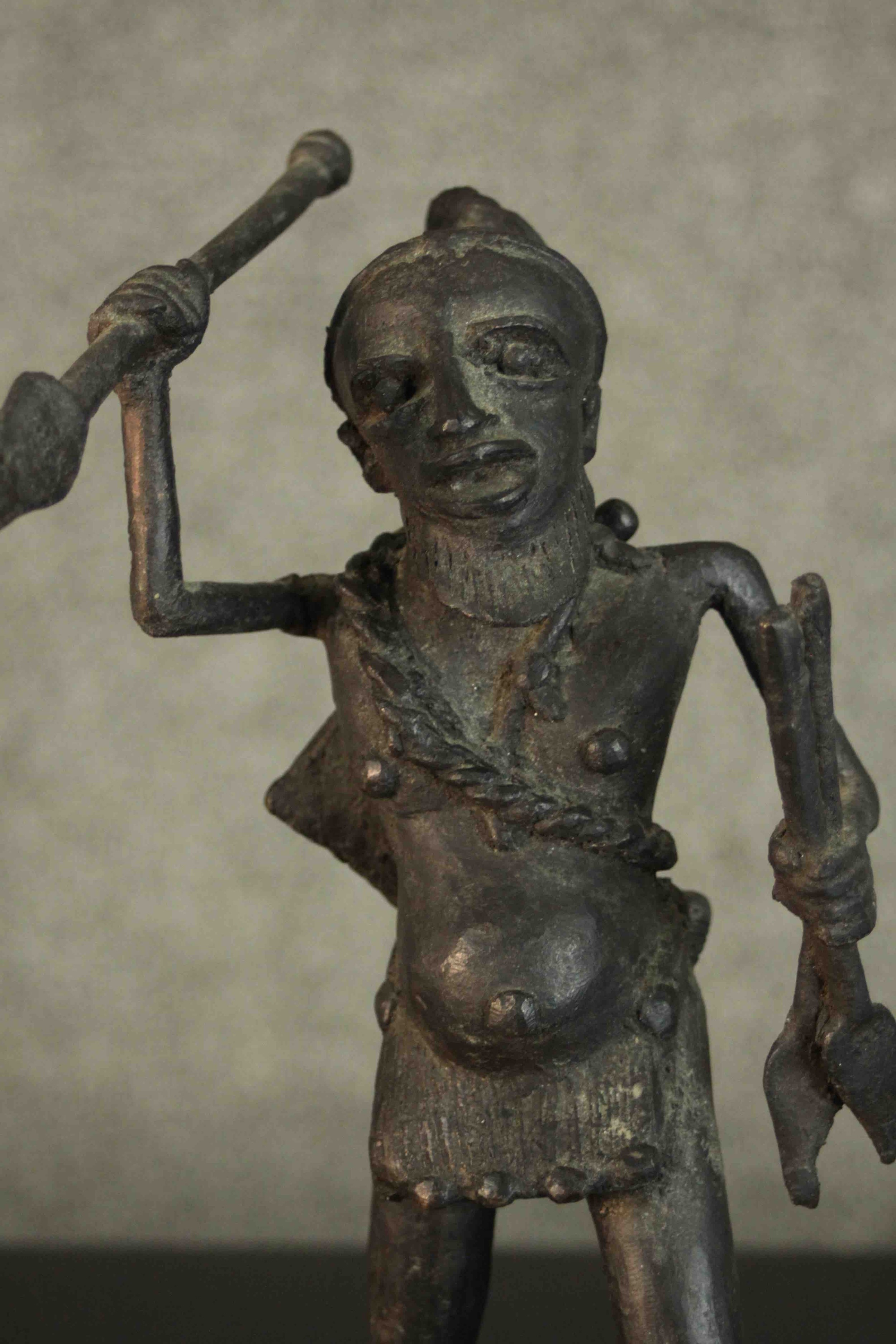An African tribal bronze figure of a warrior throwing a spear. H.31 W.12cm - Image 3 of 7