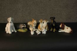 A collection of nine hand painted porcelain and ceramic animals including, different breeds of