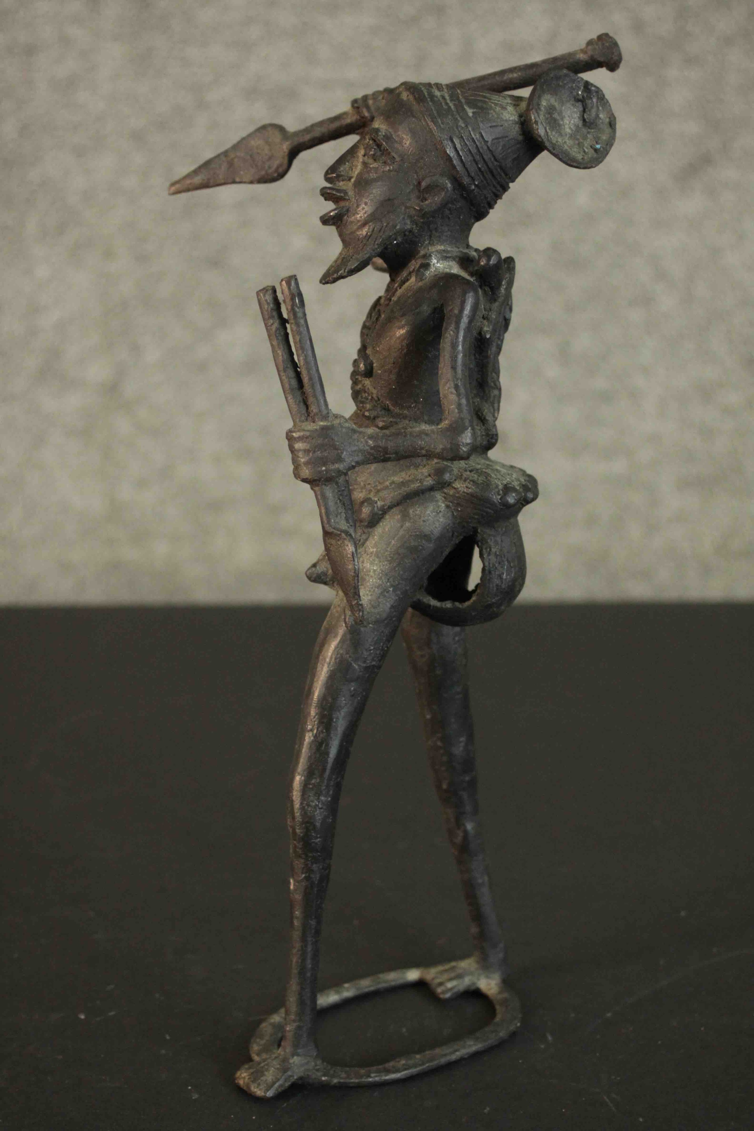 An African tribal bronze figure of a warrior throwing a spear. H.31 W.12cm - Image 4 of 7